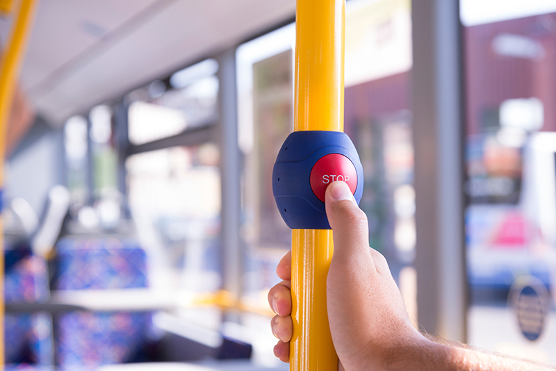 pressing the next stop button in a bus to alert the driver